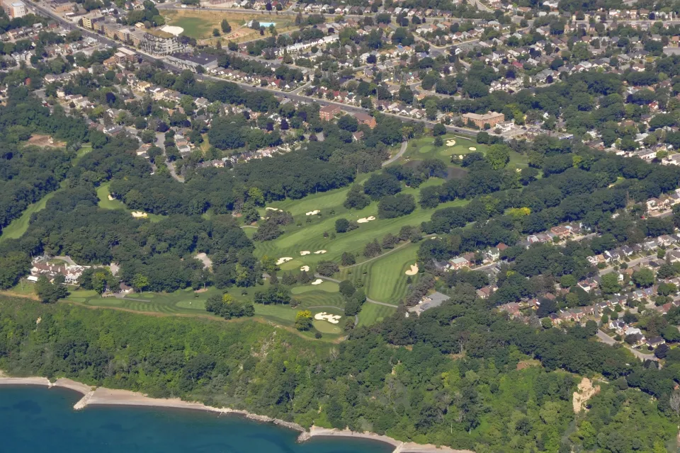 An aerial view of the Toronto Hunt Club and golf course, located along Lake Ontario amid residential homes in Toronto.